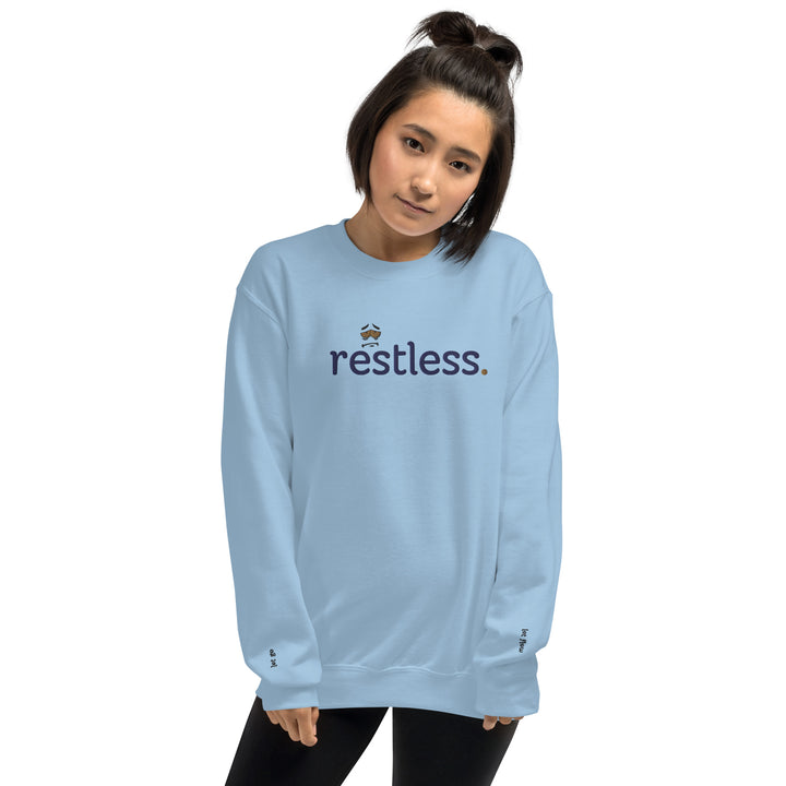 Woman wearing eco-friendly light blue sweatshirt, pre-shrunk with a classic fit, made from soft air-jet spun yarn, perfect for keeping warm in cooler weather.