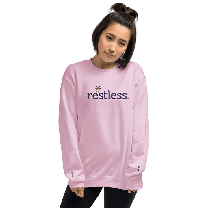 Woman wearing eco-friendly light pink sweatshirt, pre-shrunk with a classic fit, made from soft air-jet spun yarn, perfect for keeping warm in cooler weather.