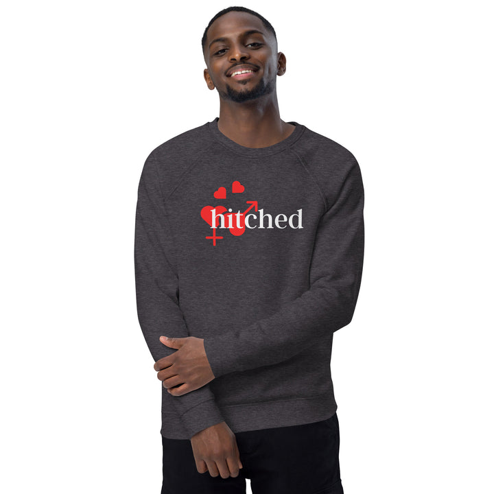 Men's organic raglan sweatshirt in charcoal melange with a playful 'Hitched' graphic. Sustainable fashion with a touch of fun.