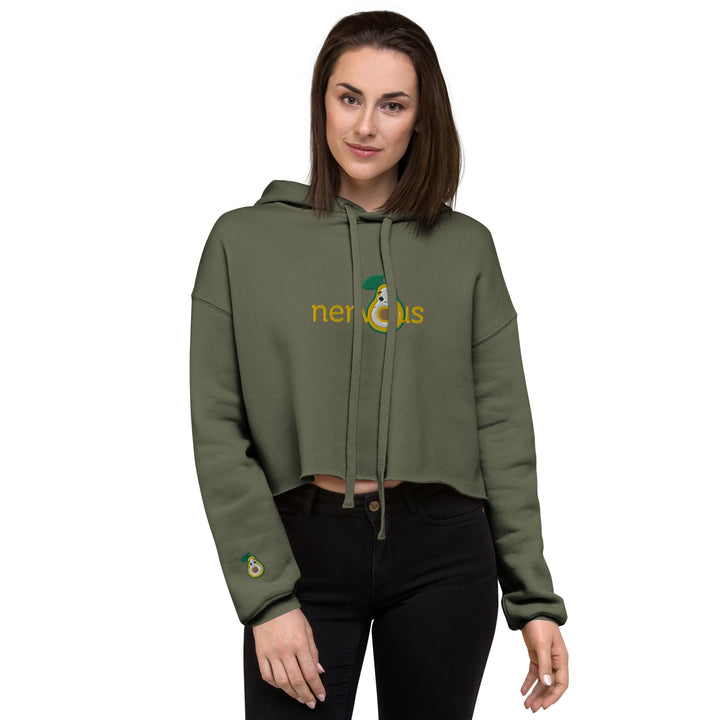 Model in a trendy 'Nervous Nut' Cropped Hoodie featuring a raw hem and cozy fit, embodying effortless urban style.  Military green crop hoodie