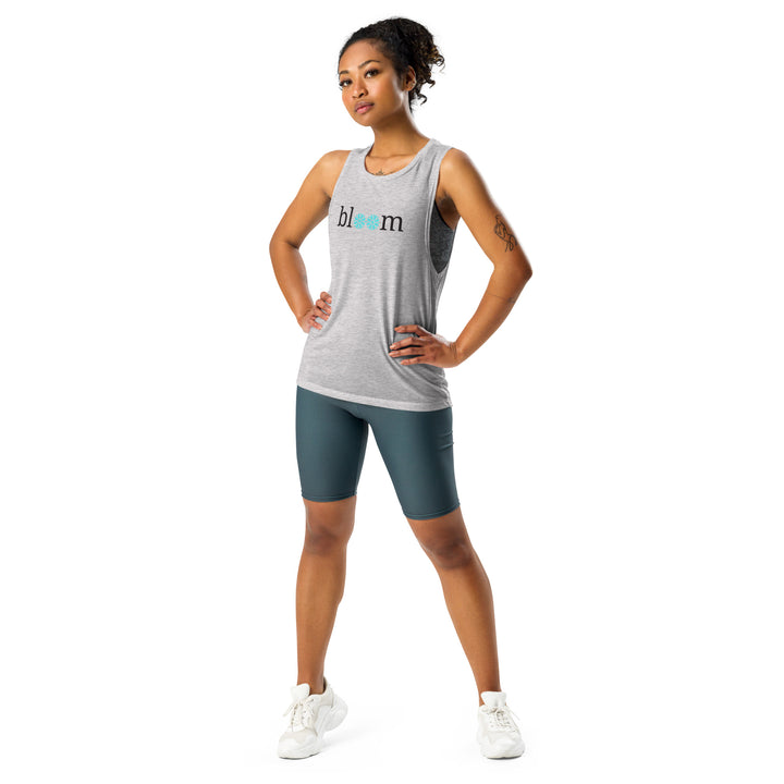 "'Bloom' Women's Muscle Tank Top on a model in motion, inspiring movement and growth in your fitness journey. The tank's design allows for a full range of movement, making it perfect for any workout.