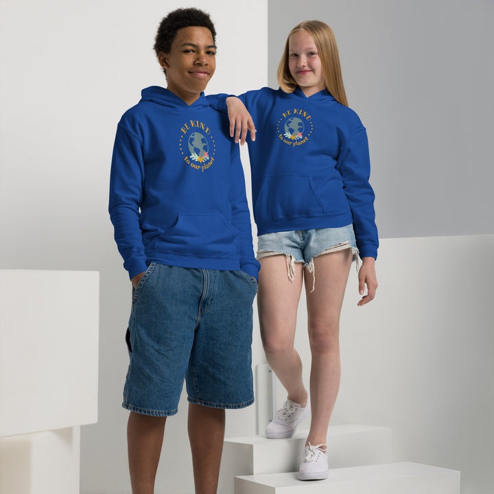 Youth in royal blue hoodie with 'Be Kind' logo standing confidently, showcasing the double-lined hood and front pouch pocket